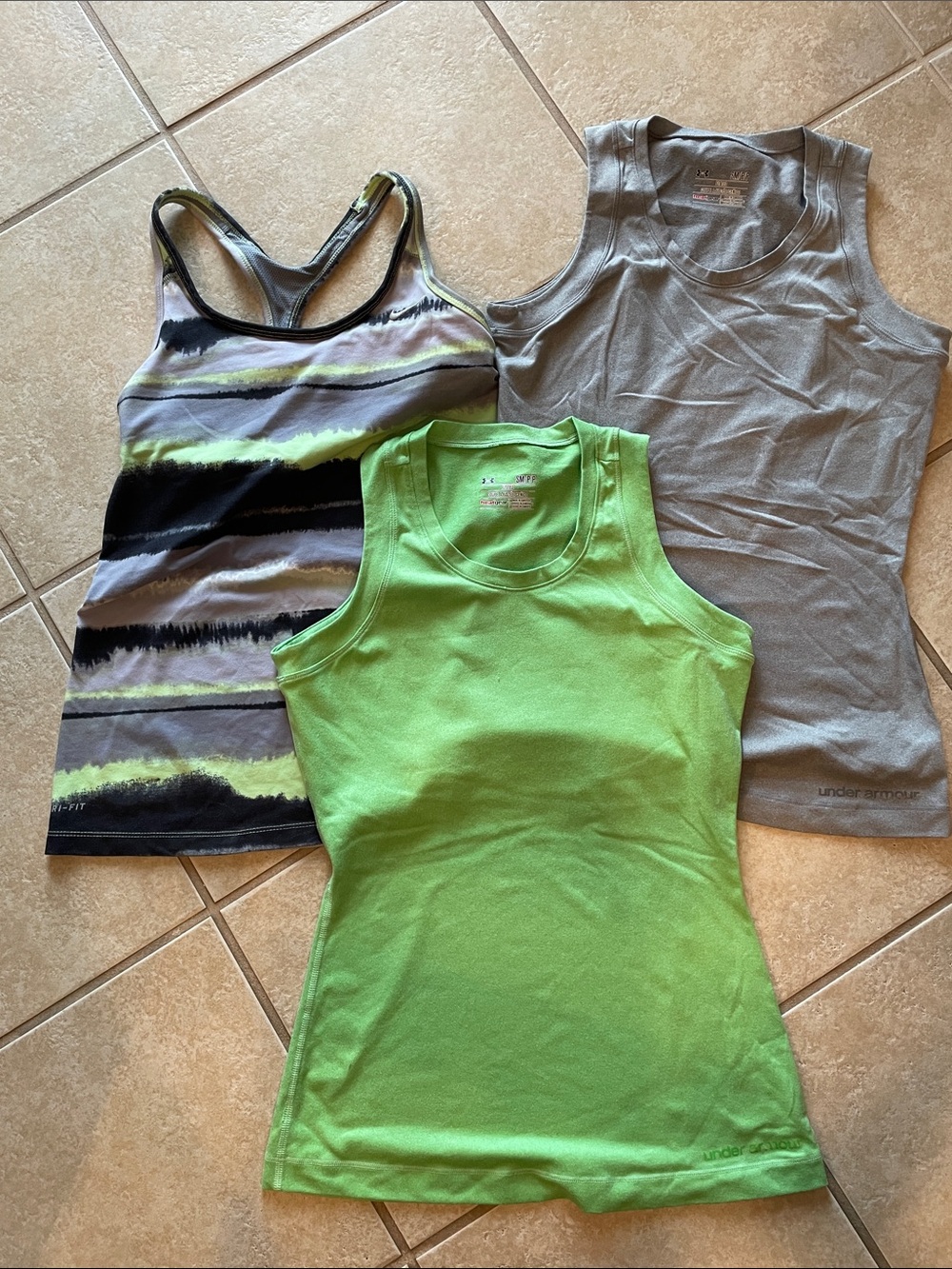 Women’s Under Armour and Nike tanks. UA tops are size S. Nike top is size M.